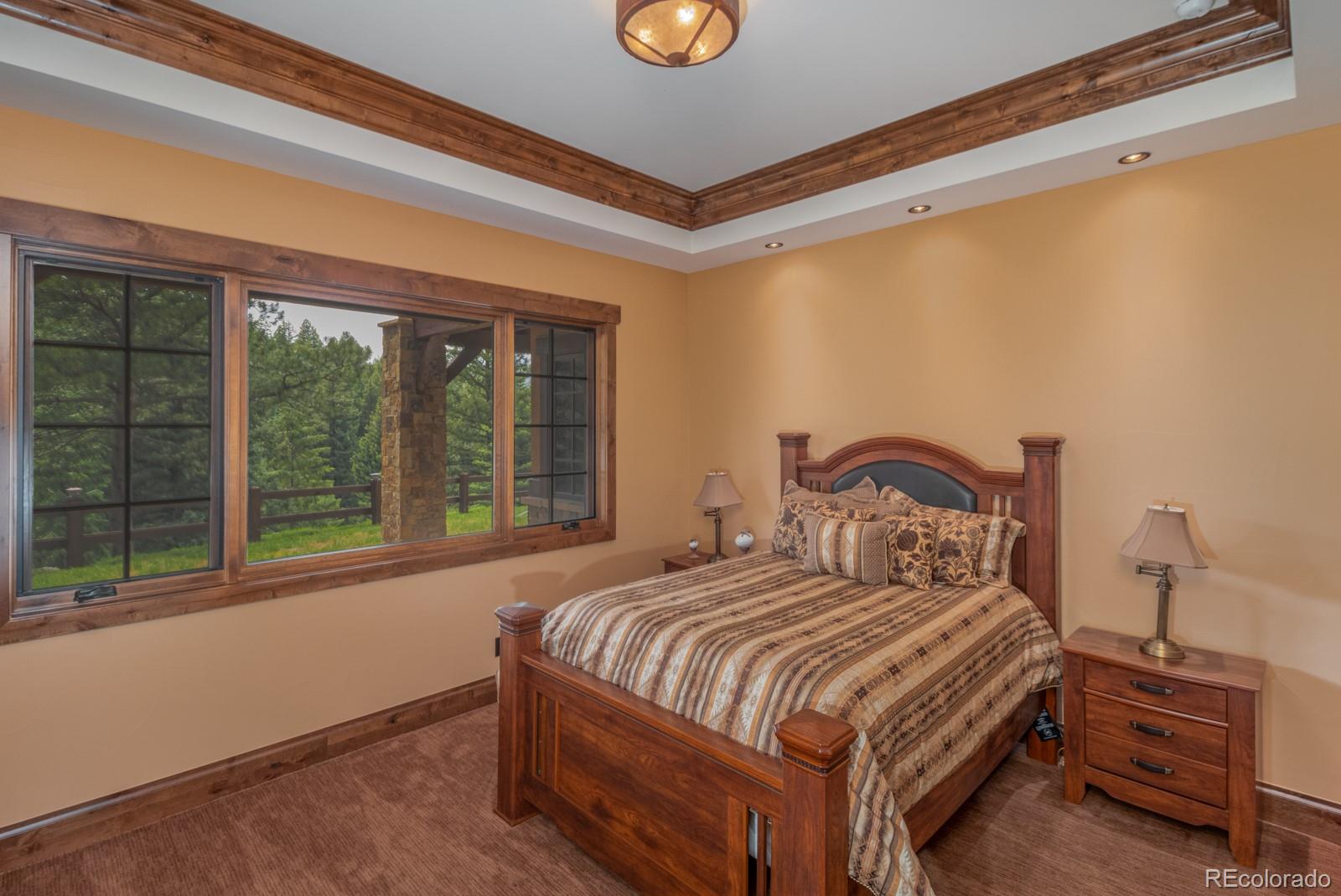 30 West Ranch Trail Morrison, CO 80465 - Photo 25 of 40 a bedroom with a bed and a window