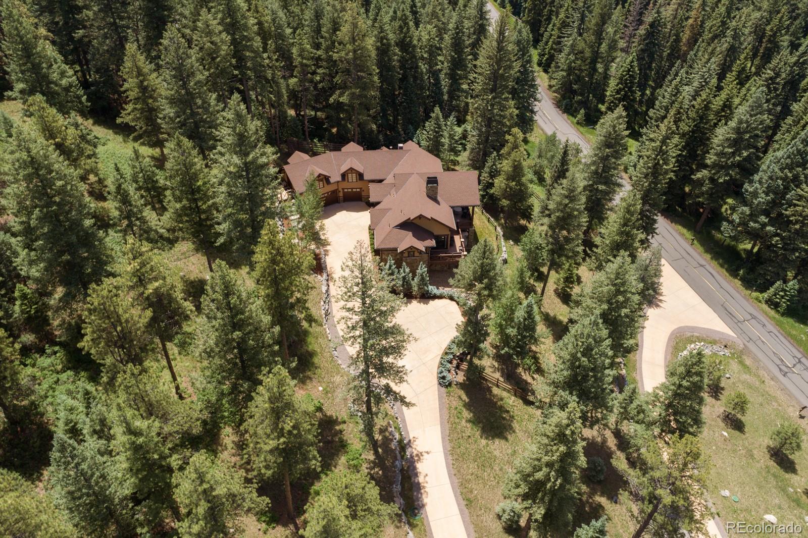 30 West Ranch Trail Morrison, CO 80465 - Photo 3 of 40 a view of a house with a yard