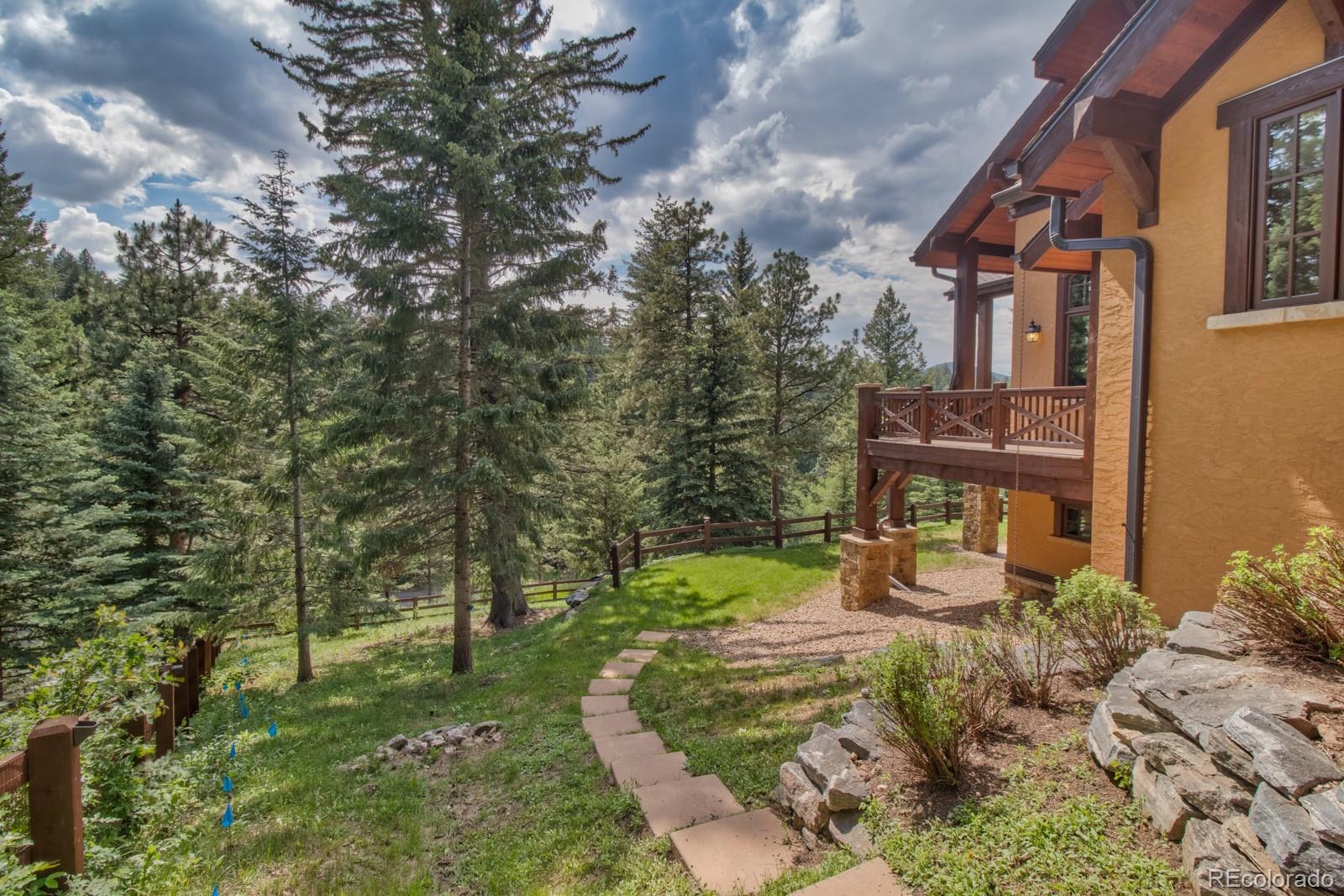 30 West Ranch Trail Morrison, CO 80465 - Photo 36 of 40 a view of a house with a yard