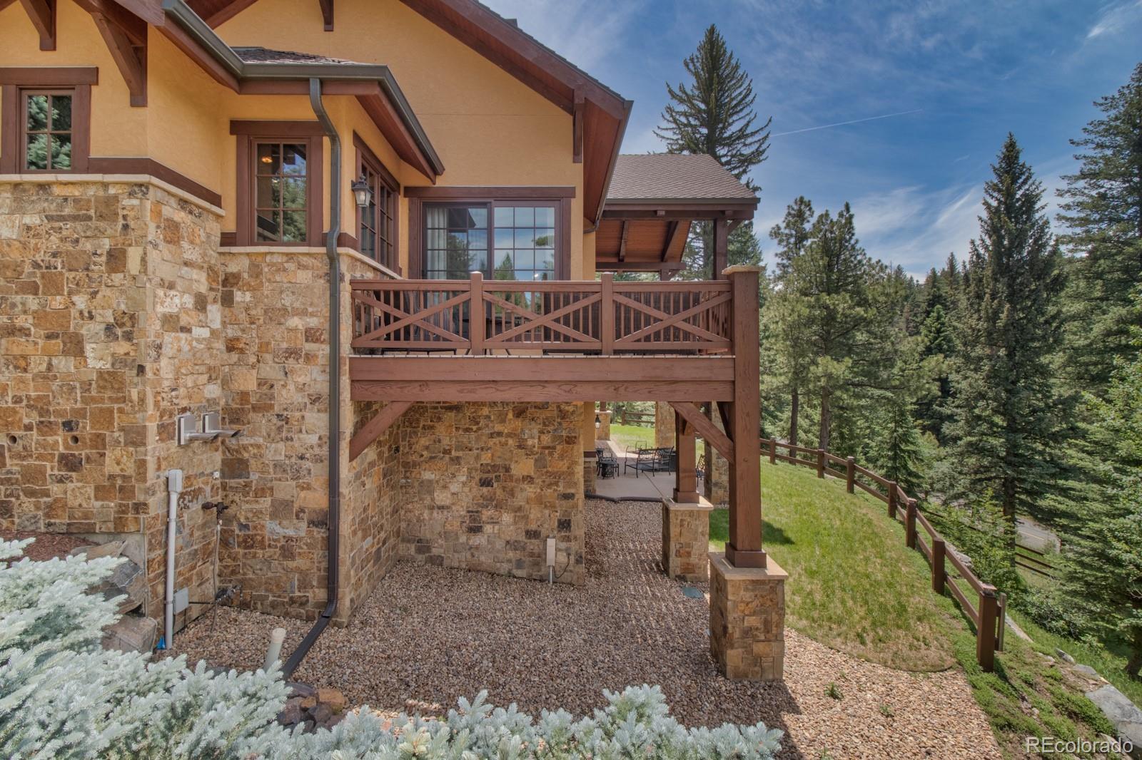 30 West Ranch Trail Morrison, CO 80465 - Photo 37 of 40 front view of a house with a yard