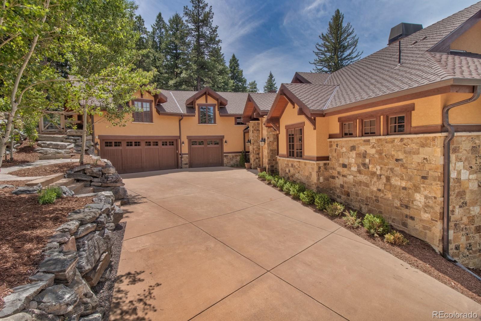 30 West Ranch Trail Morrison, CO 80465 - Photo 7 of 40 a view of a house with a small yard and large tree