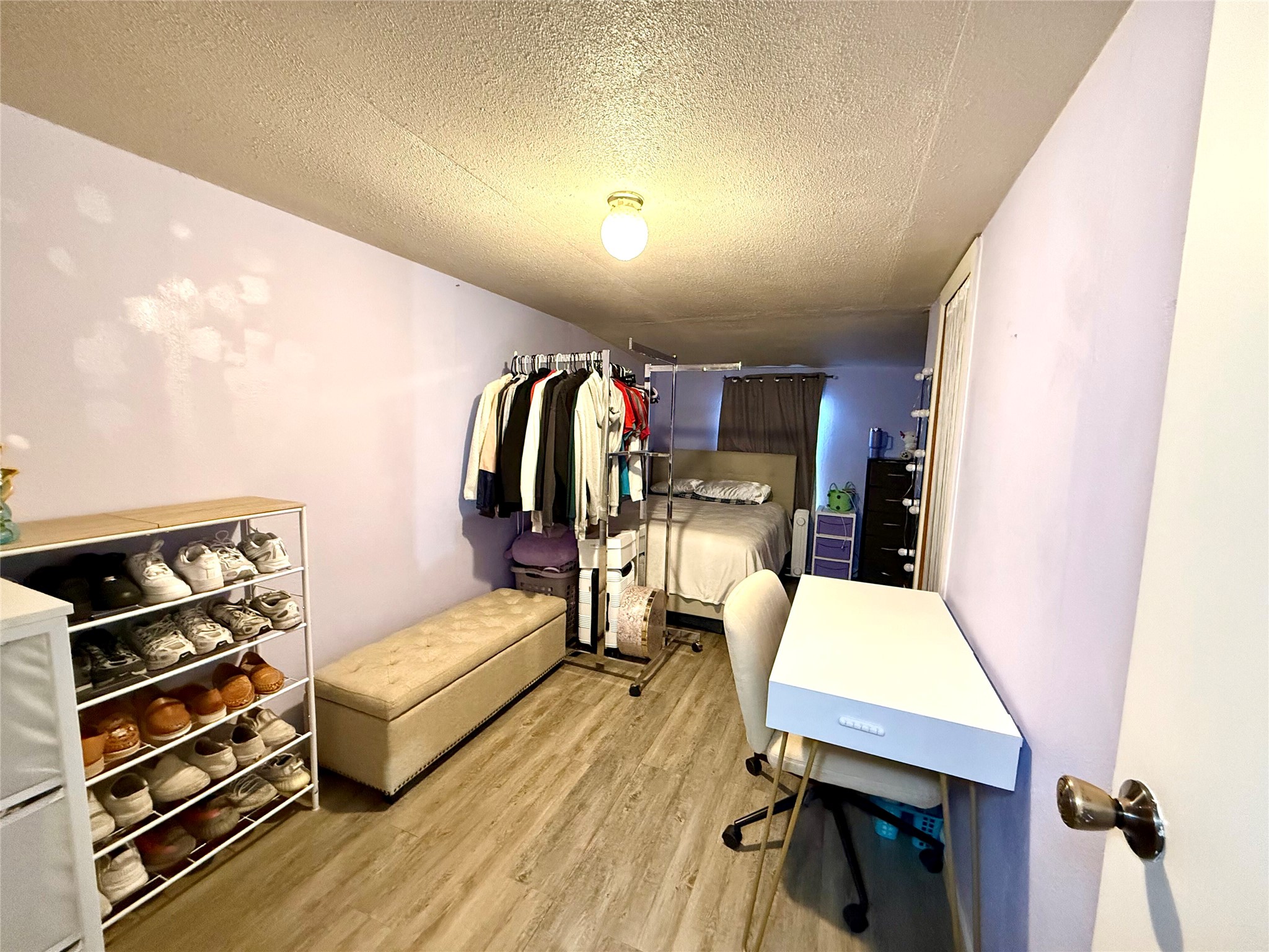 685 Fox Lane Lockhart, TX 78644 - Photo 11 of 39 Bedroom with a textured ceiling and light wood-style flooring