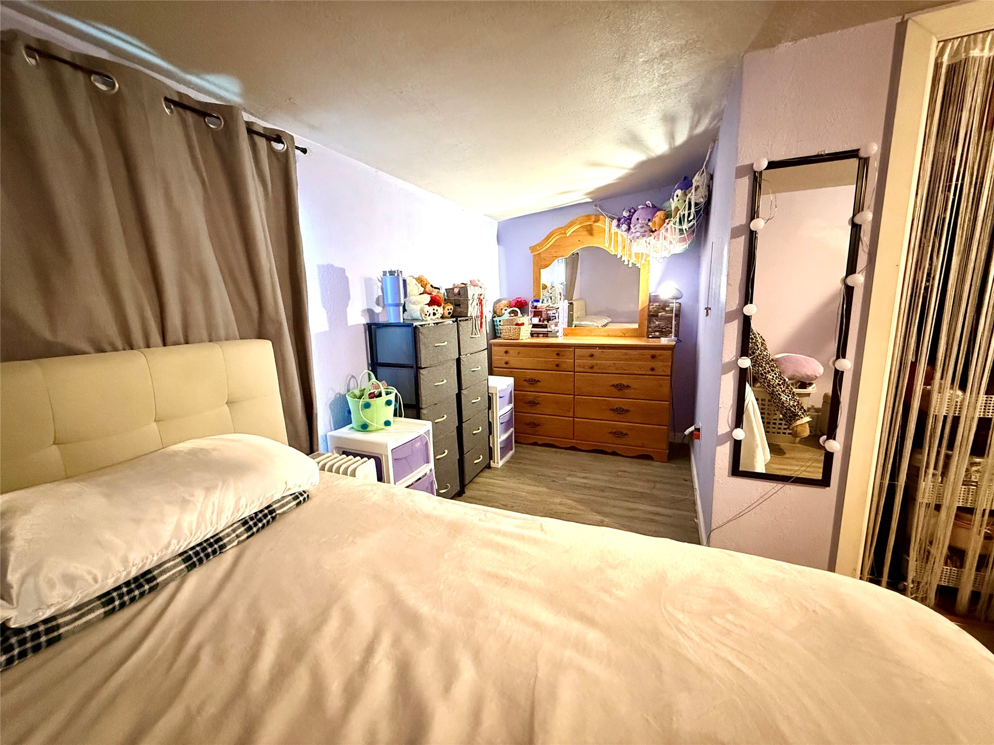 685 Fox Lane Lockhart, TX 78644 - Photo 12 of 39 Bedroom featuring a textured ceiling and wood finished floors