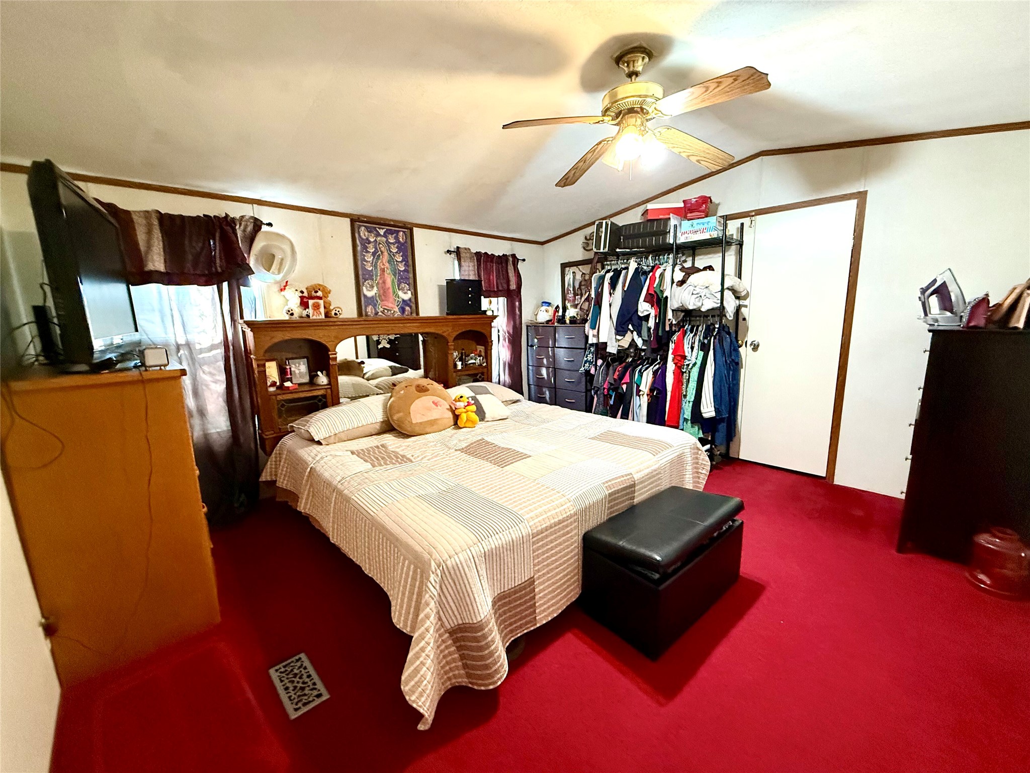 685 Fox Lane Lockhart, TX 78644 - Photo 18 of 39 Bedroom featuring ornamental molding, lofted ceiling, a ceiling fan, and carpet