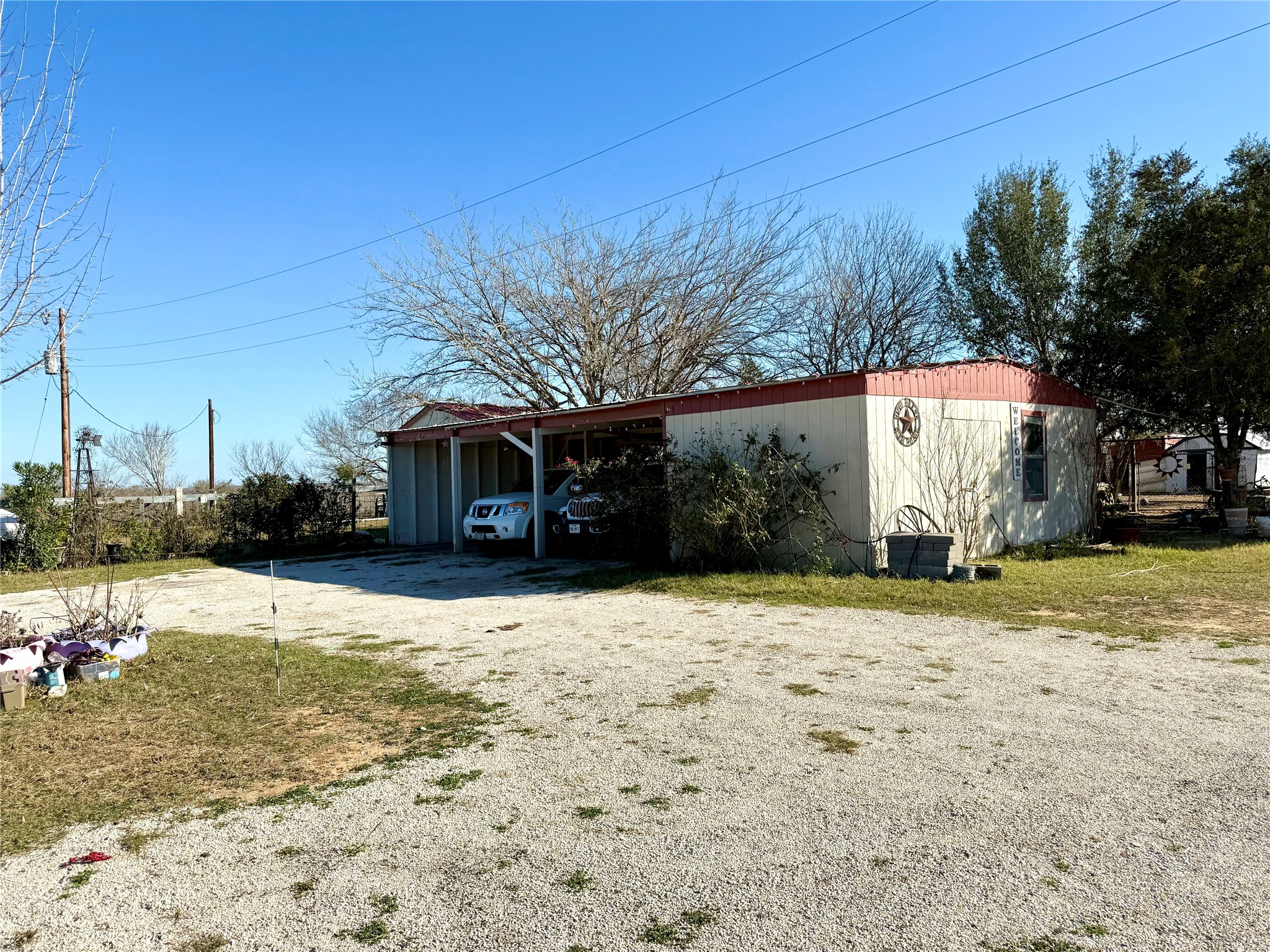 685 Fox Lane Lockhart, TX 78644 - Photo 2 of 39 View of outbuilding with a carport and driveway