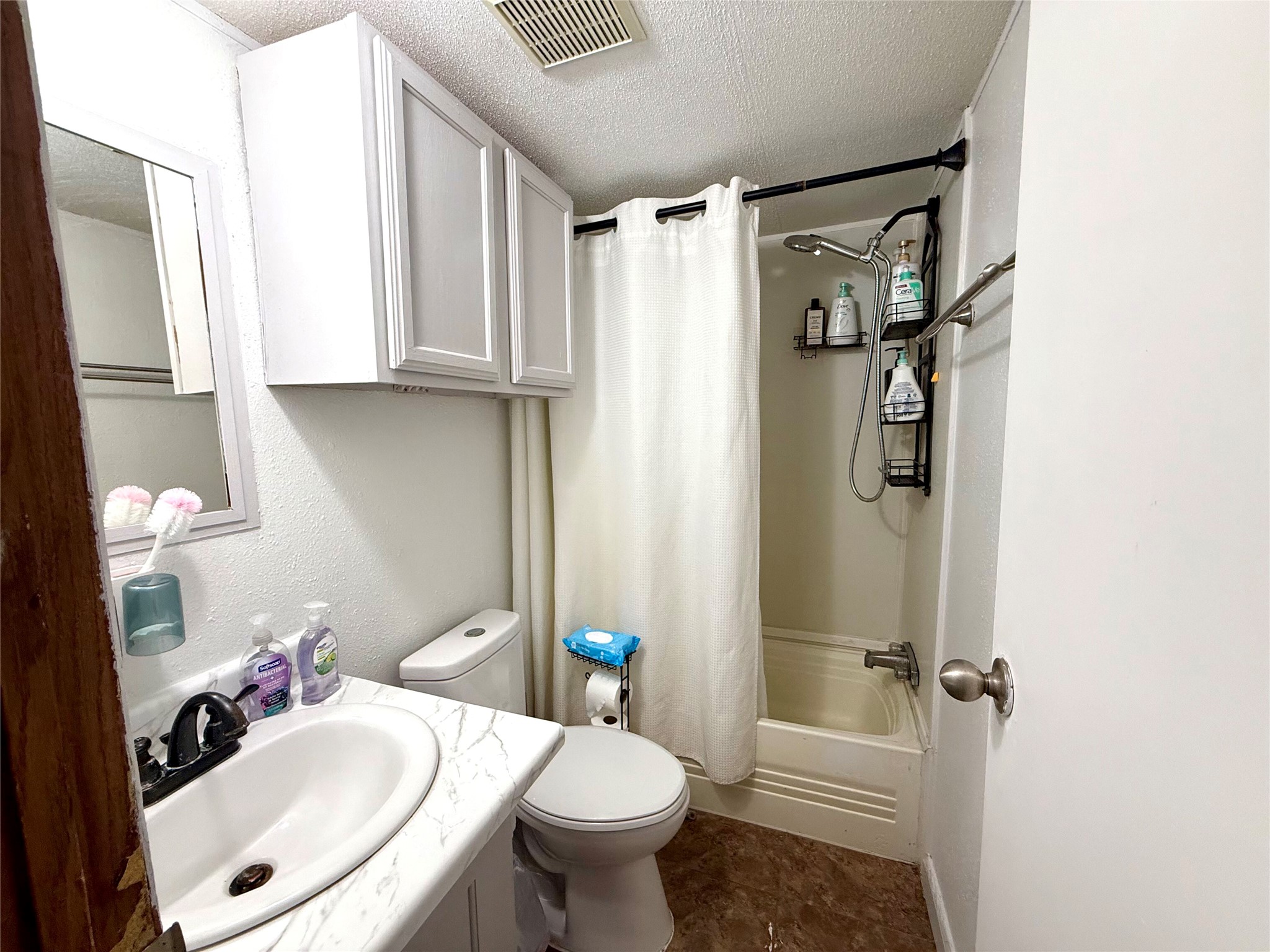 685 Fox Lane Lockhart, TX 78644 - Photo 9 of 39 Bathroom with a textured ceiling, shower / tub combo, and double vanity