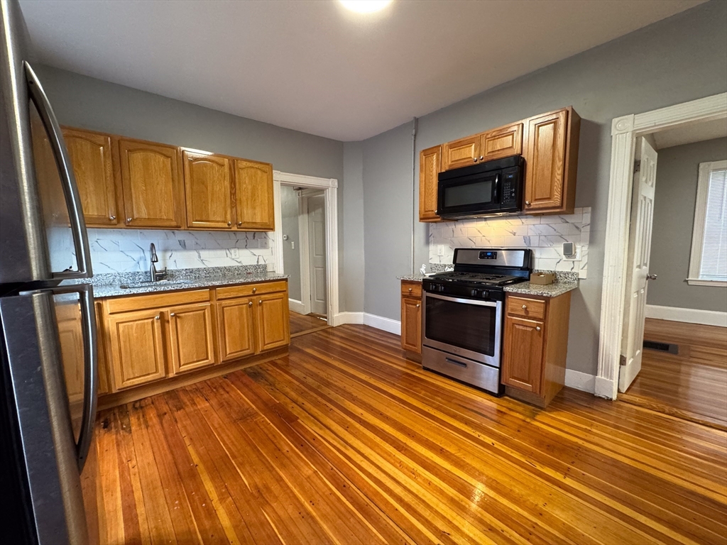 12 Dalrymple Street, Unit 2 Boston, MA 02130 - Photo 1 of 21 a kitchen with stainless steel appliances a stove sink and microwave
