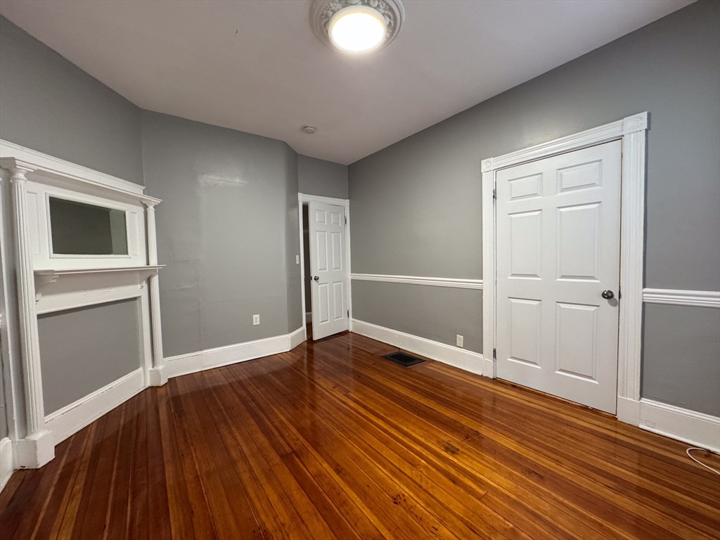 12 Dalrymple Street, Unit 2 Boston, MA 02130 - Photo 14 of 21 an empty room with wooden floor and windows