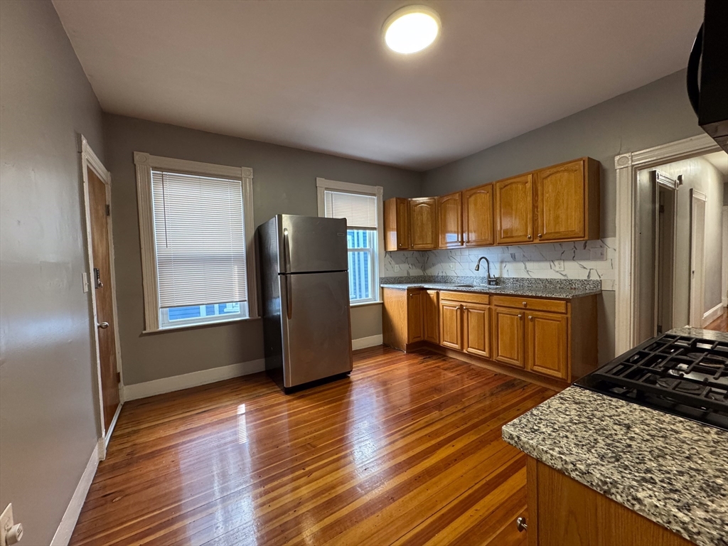 12 Dalrymple Street, Unit 2 Boston, MA 02130 - Photo 4 of 21 a kitchen with a refrigerator and a stove top oven