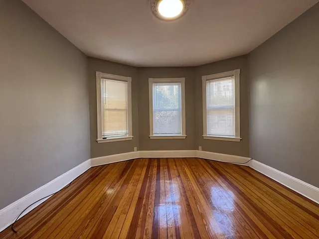 a view of room with window and hardwood floor