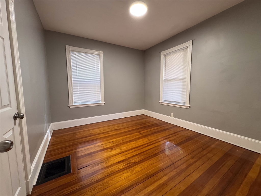 12 Dalrymple Street, Unit 2 Boston, MA 02130 - Photo 10 of 21 an empty room with wooden floor and windows