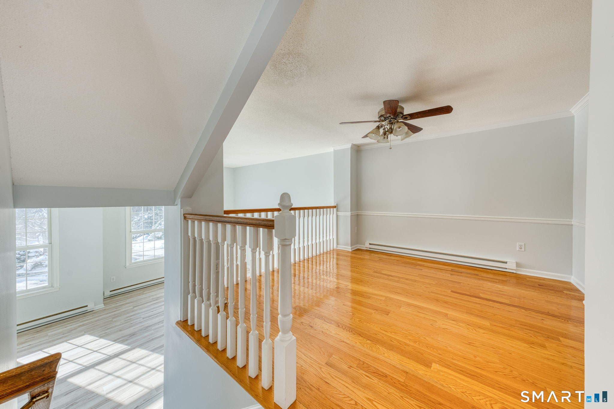 350 Bristol Street, Unit C1 Waterbury, CT 06708 - Photo 11 of 40 a view of a livingroom with wooden floor and a ceiling fan