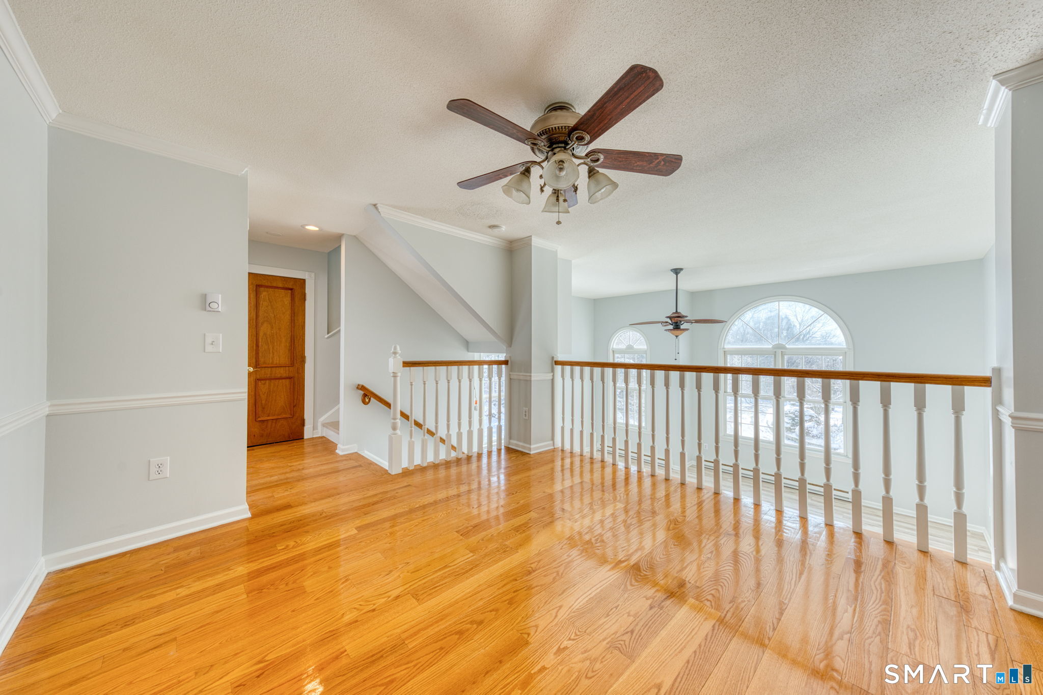 350 Bristol Street, Unit C1 Waterbury, CT 06708 - Photo 13 of 40 a view of a livingroom with wooden floor and a ceiling fan