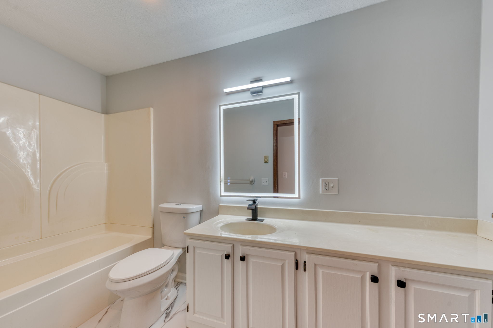 350 Bristol Street, Unit C1 Waterbury, CT 06708 - Photo 17 of 40 a bathroom with a granite countertop sink a toilet and a bathtub