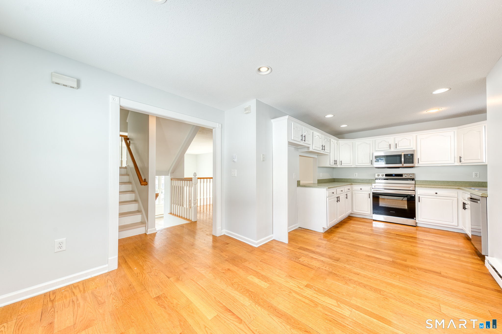 350 Bristol Street, Unit C1 Waterbury, CT 06708 - Photo 23 of 40 a kitchen with stainless steel appliances kitchen island granite countertop a refrigerator and cabinets