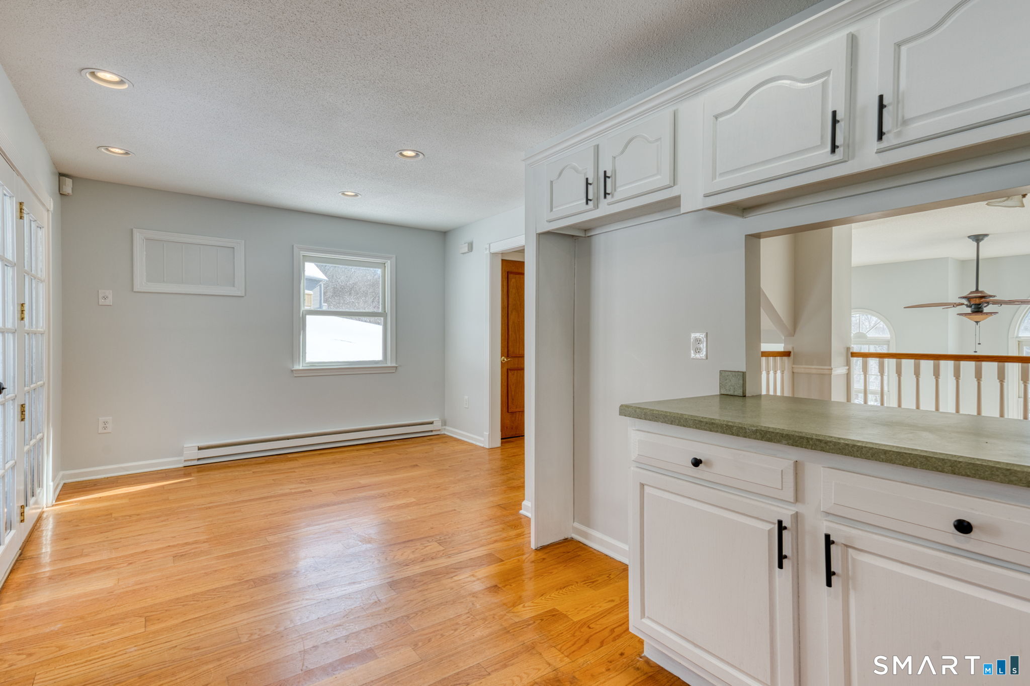 350 Bristol Street, Unit C1 Waterbury, CT 06708 - Photo 27 of 40 a kitchen with granite countertop white cabinets and window