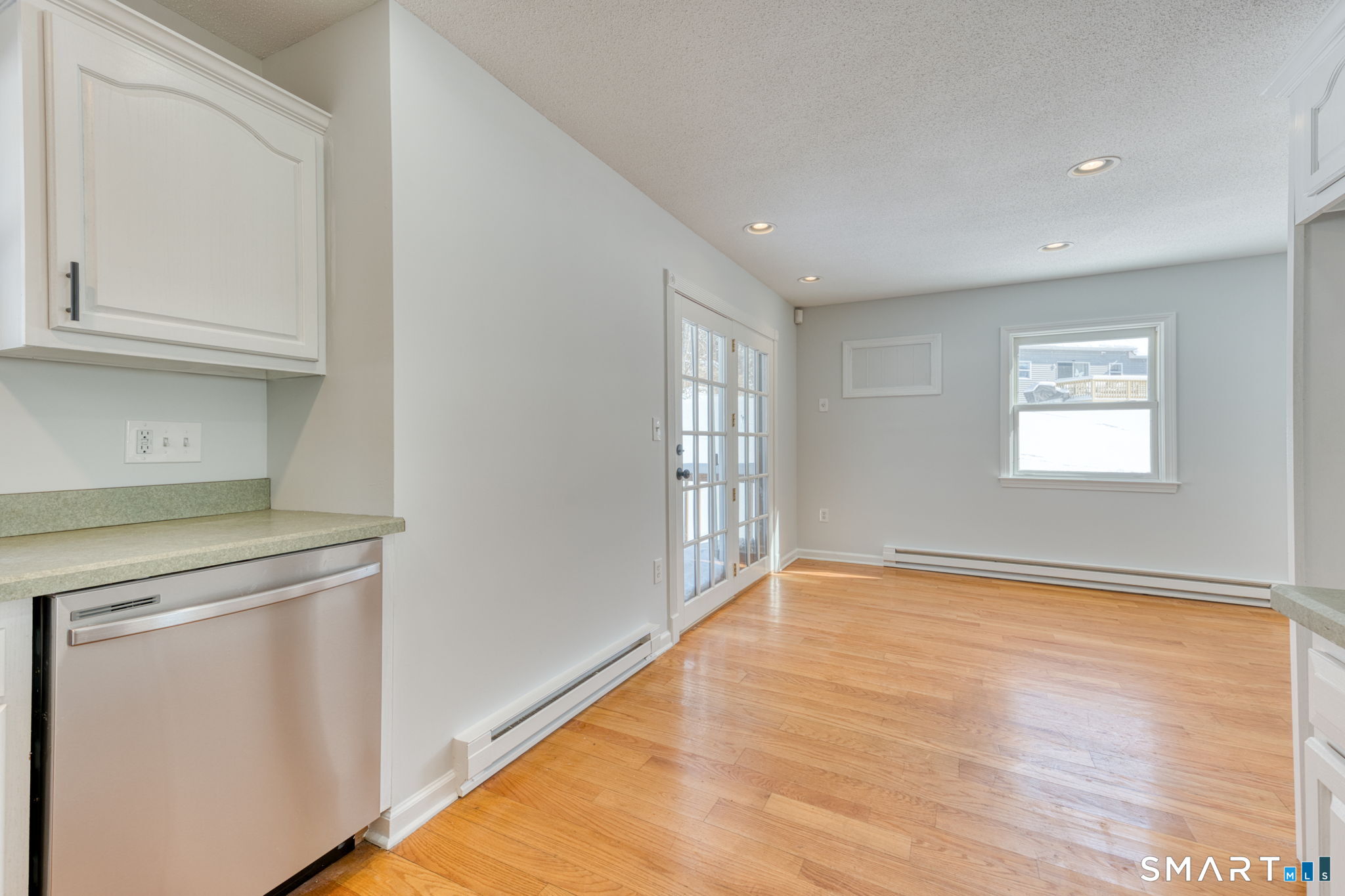 350 Bristol Street, Unit C1 Waterbury, CT 06708 - Photo 28 of 40 a view of an empty room with wooden floor and a window