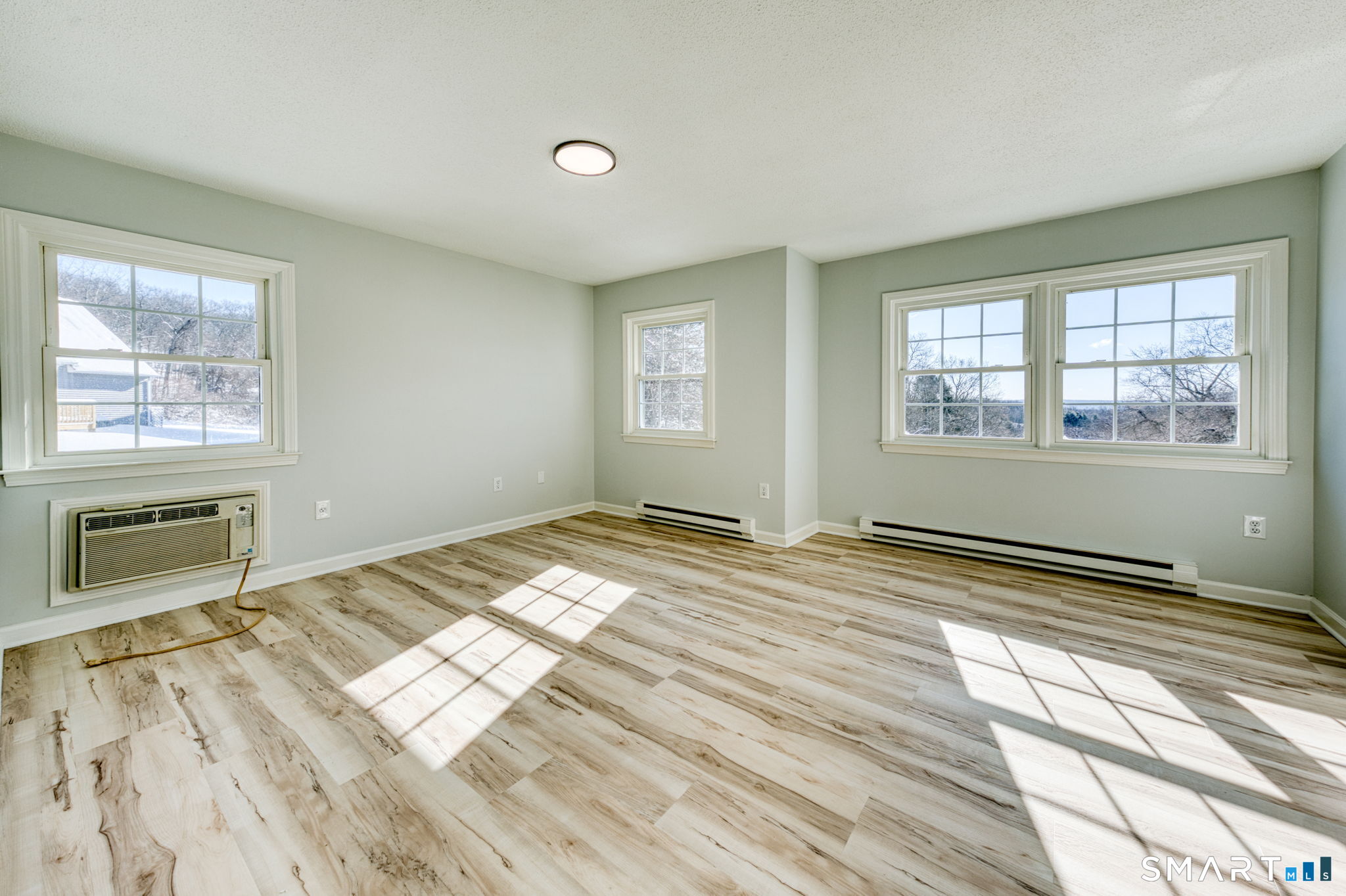350 Bristol Street, Unit C1 Waterbury, CT 06708 - Photo 32 of 40 a view of a bedroom with wooden floor and windows
