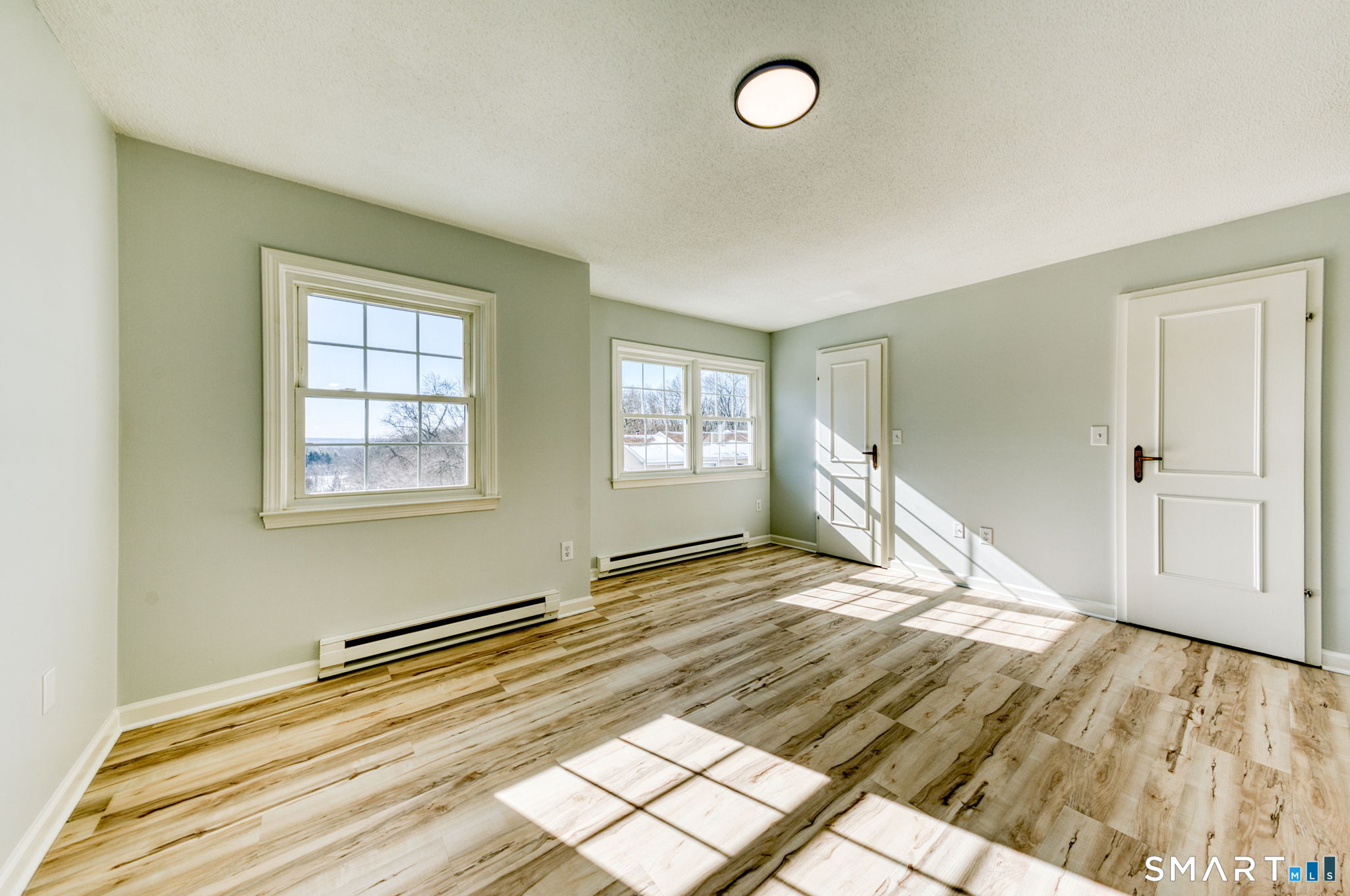 350 Bristol Street, Unit C1 Waterbury, CT 06708 - Photo 33 of 40 a view of empty room with wooden floor and fan