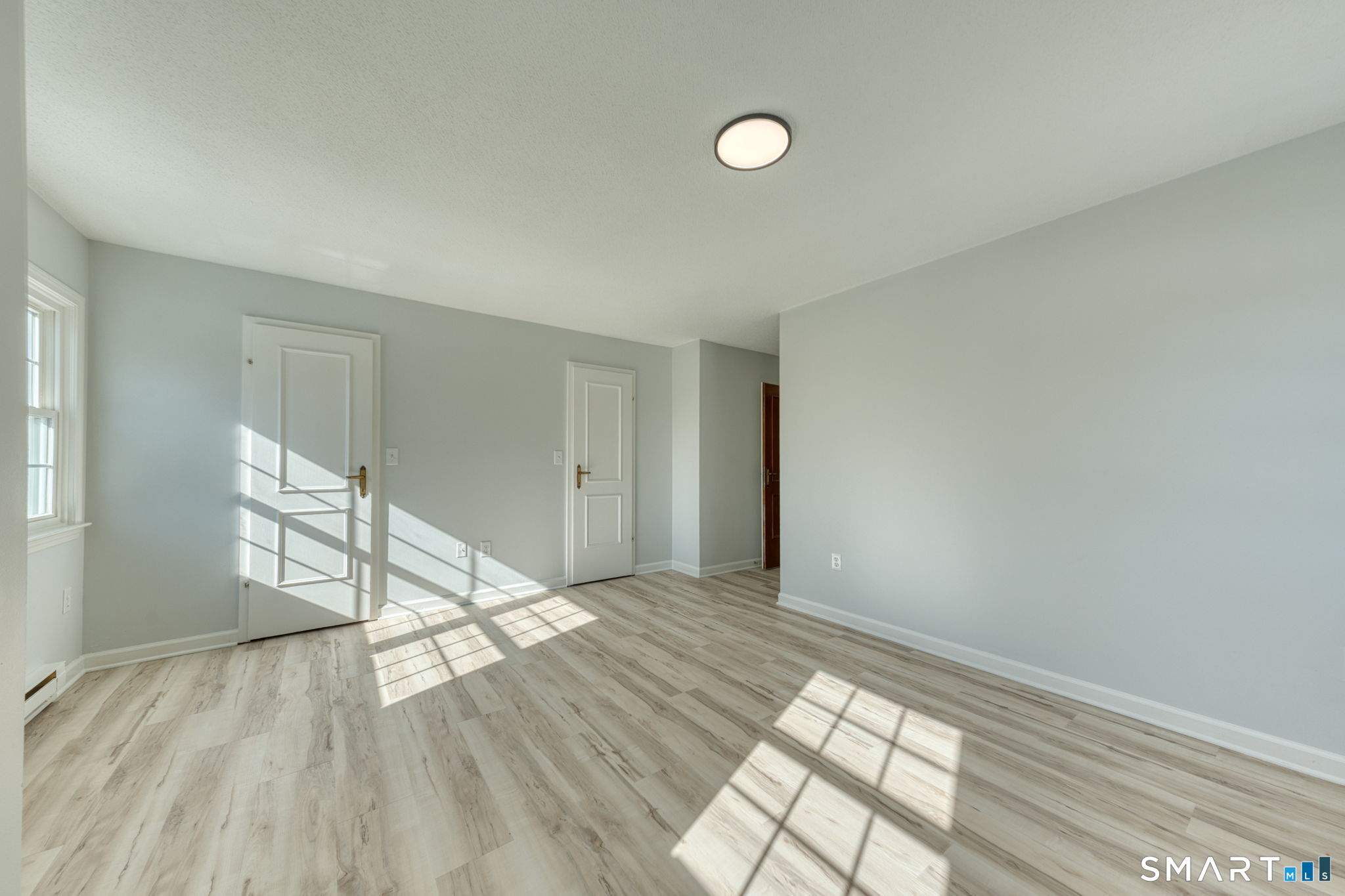 350 Bristol Street, Unit C1 Waterbury, CT 06708 - Photo 34 of 40 a view of empty room with wooden floor and fan