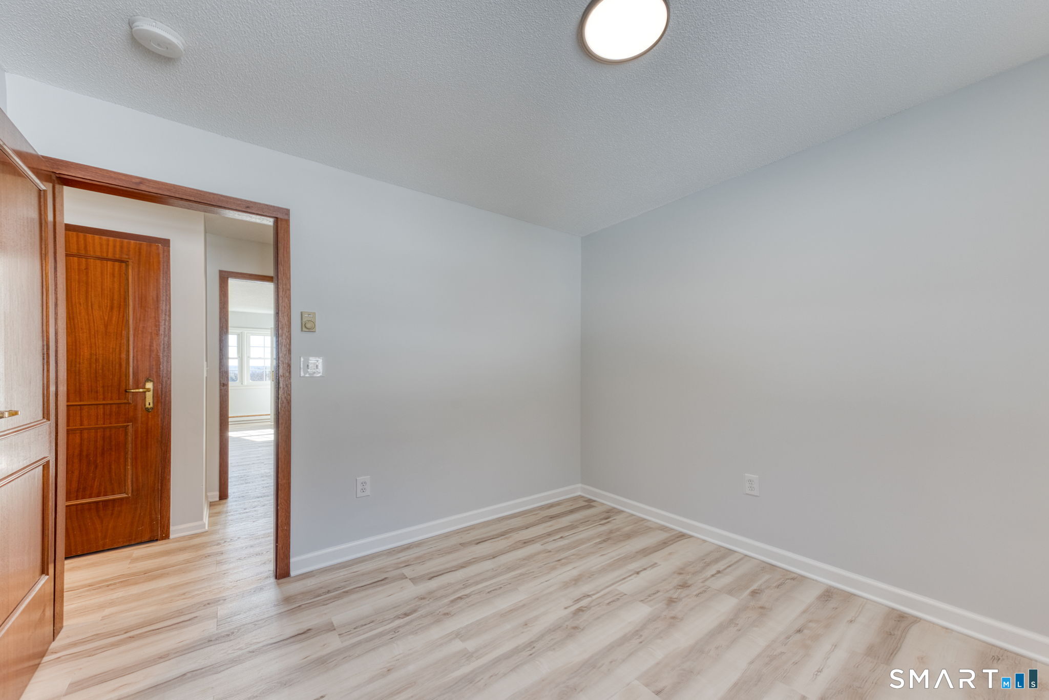350 Bristol Street, Unit C1 Waterbury, CT 06708 - Photo 37 of 40 a view of empty room with wooden floor