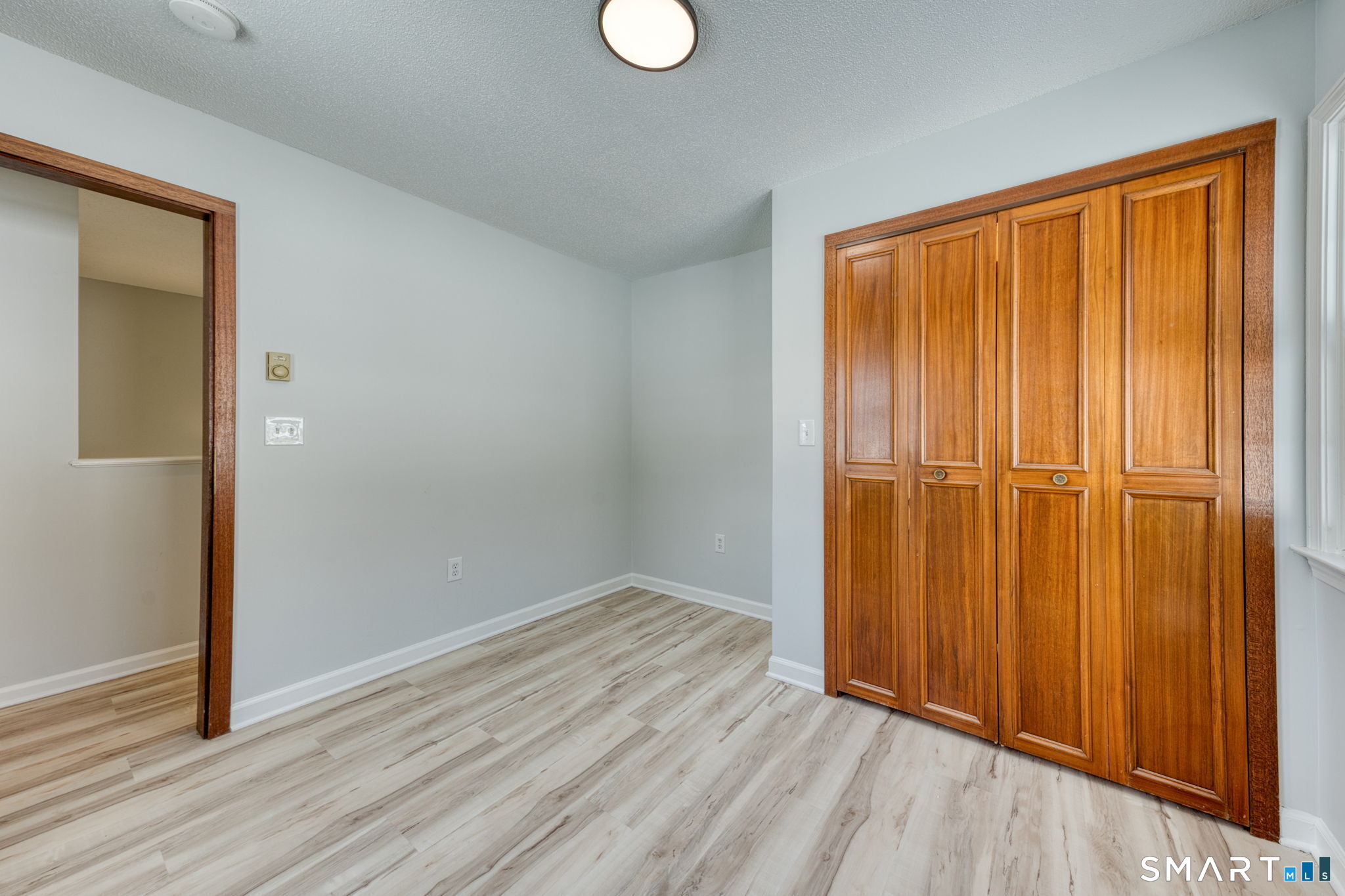 350 Bristol Street, Unit C1 Waterbury, CT 06708 - Photo 40 of 40 an empty room with wooden floor and closet