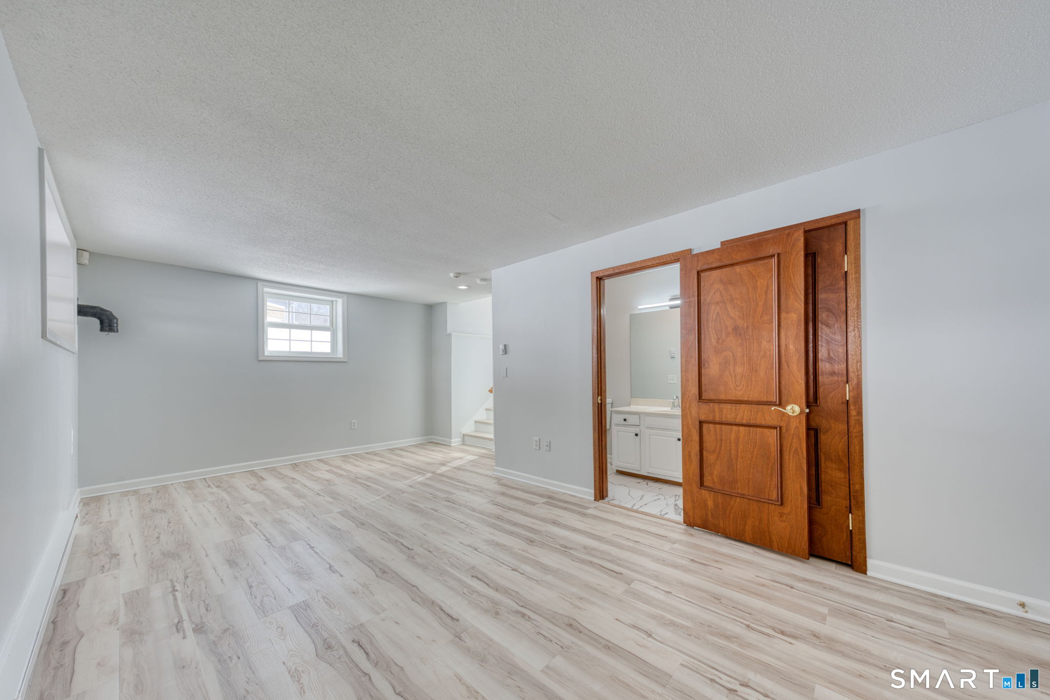 350 Bristol Street, Unit C1 Waterbury, CT 06708 - Photo 6 of 40 a view of empty room with wooden floor and fan