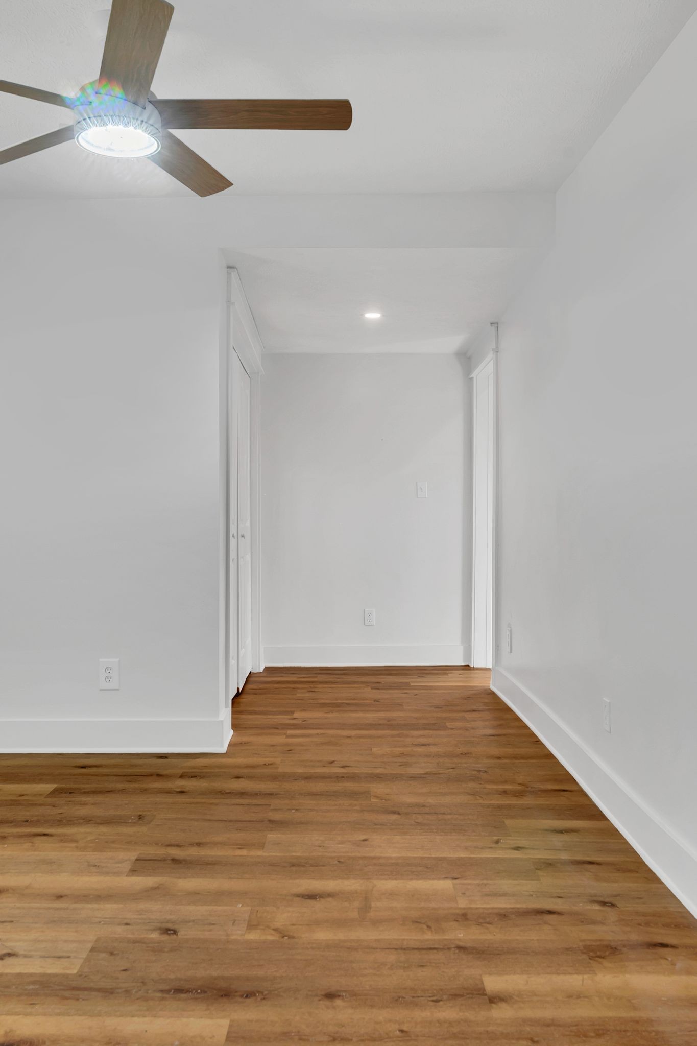 402 England Street East Cowan, TN 37318 - Photo 12 of 23 a view of an empty room with wooden floor and a ceiling fan