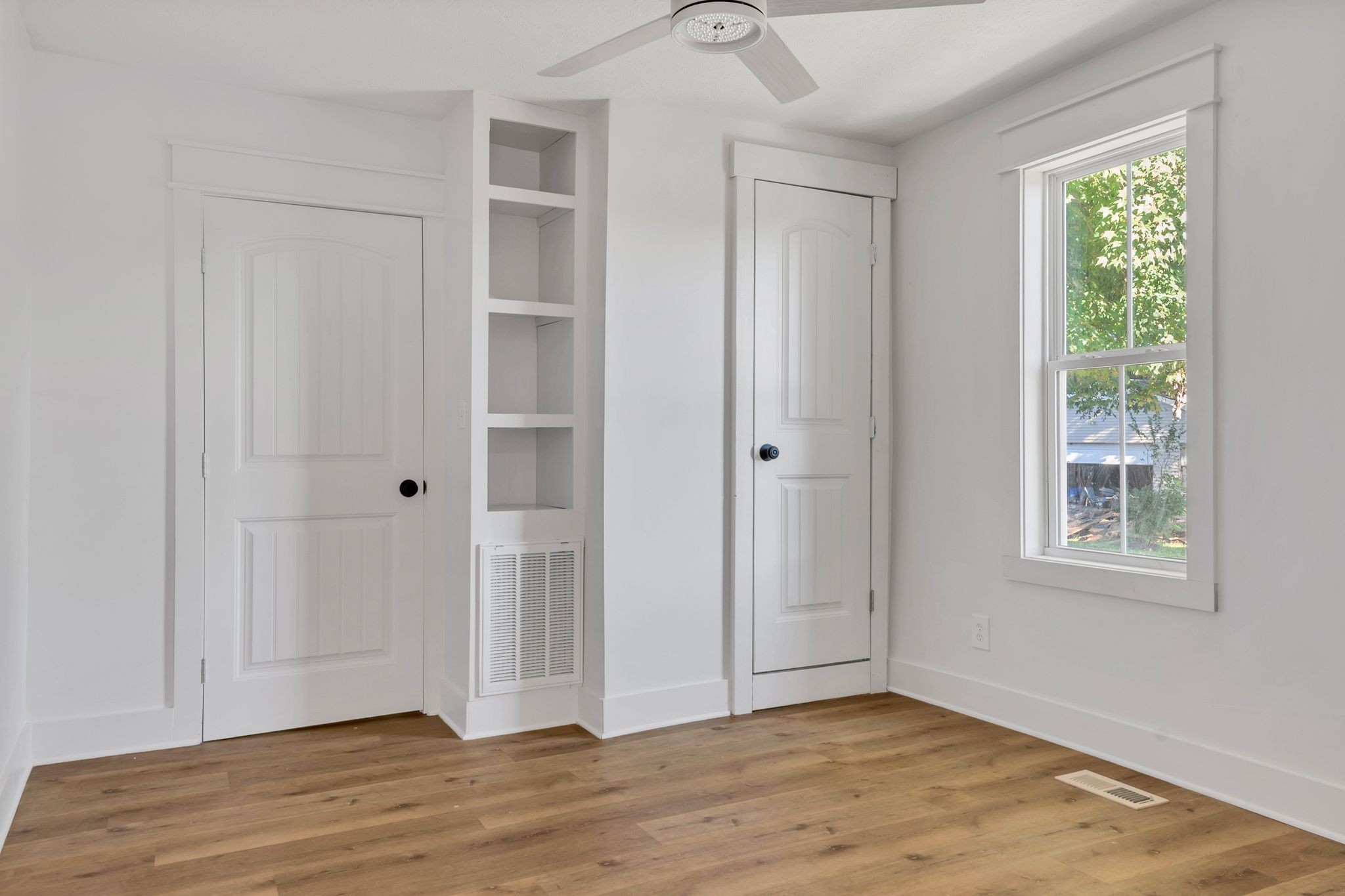 402 England Street East Cowan, TN 37318 - Photo 14 of 23 a view of an empty room with wooden floor and a window