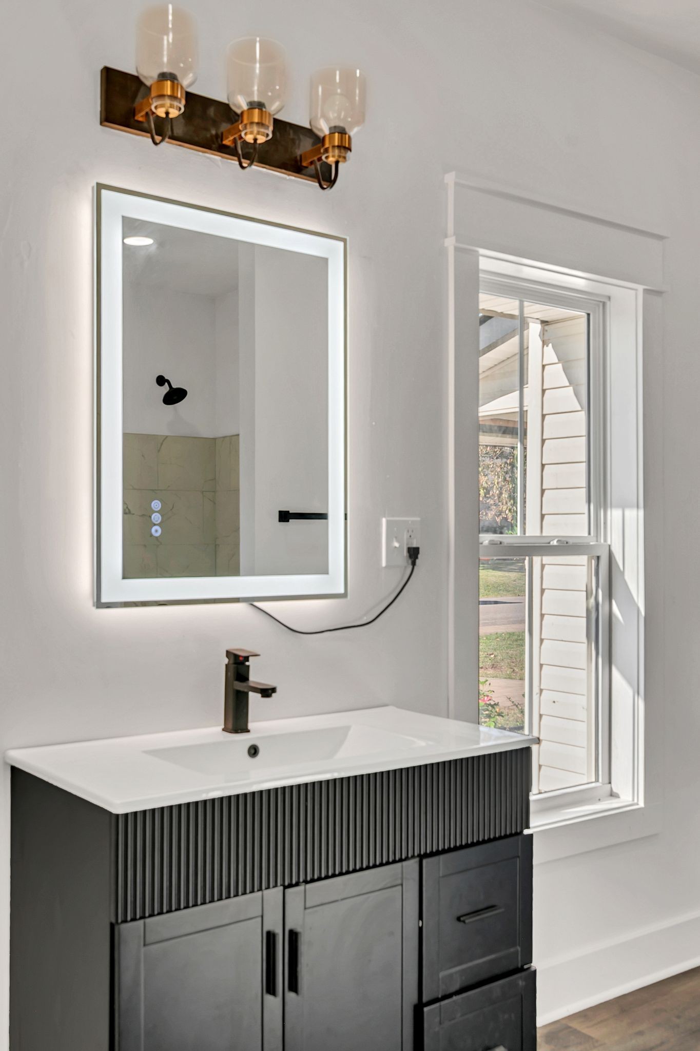 402 England Street East Cowan, TN 37318 - Photo 16 of 23 a bathroom with a sink a mirror and a window