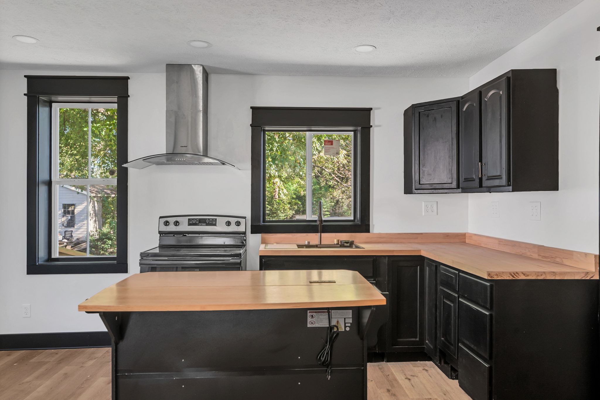402 England Street East Cowan, TN 37318 - Photo 8 of 23 a kitchen with stainless steel appliances wooden cabinets a stove a sink and a refrigerator