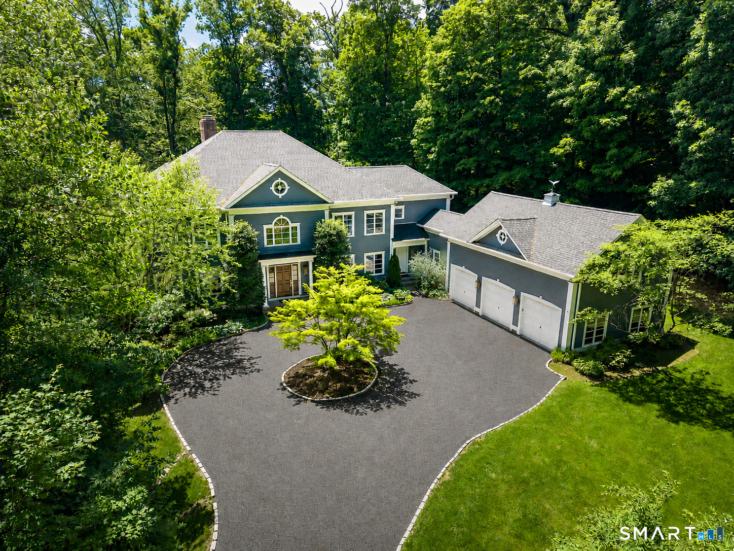 an aerial view of a house with a yard and garden