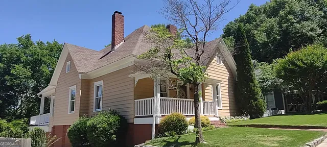 a front view of a house with outdoor seating