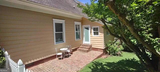 a living room with furniture a fireplace and a chandelier