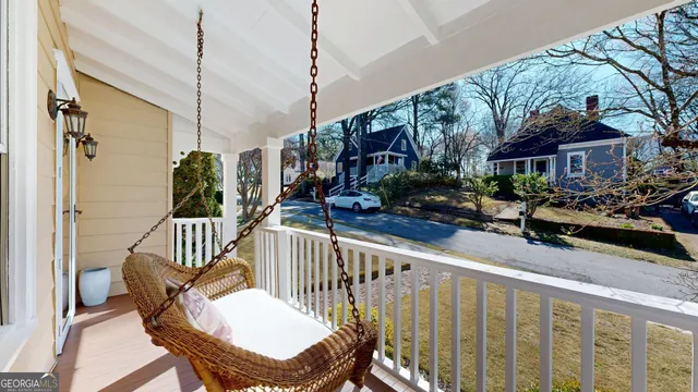 a living room with furniture a flat screen tv and a window