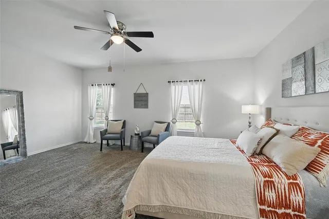 a bed room with a bed and a chair