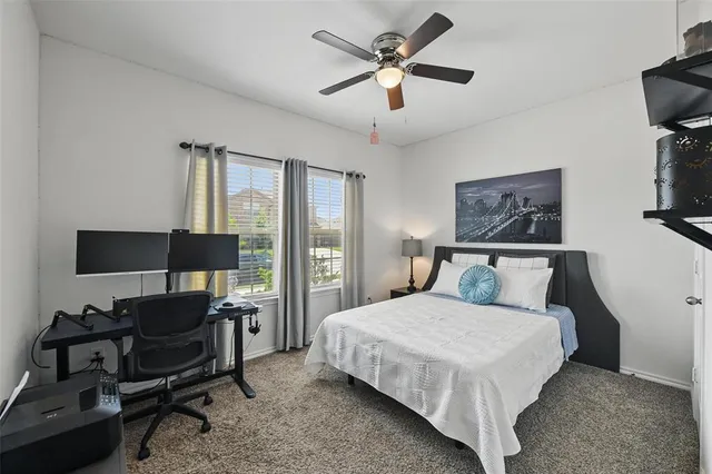 a bedroom with a bed a desk and chair