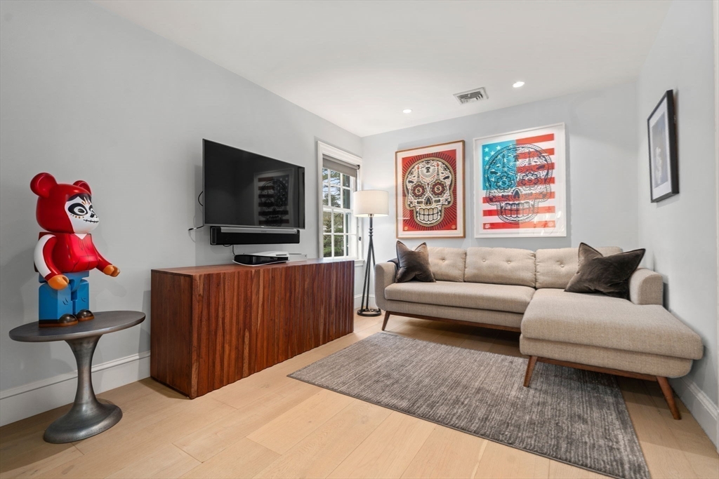 389 Grove Street Needham, MA 02492 - Photo 17 of 40 a living room with furniture and a flat screen tv