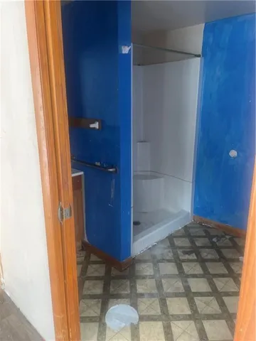a view of a room with wooden floor and windows