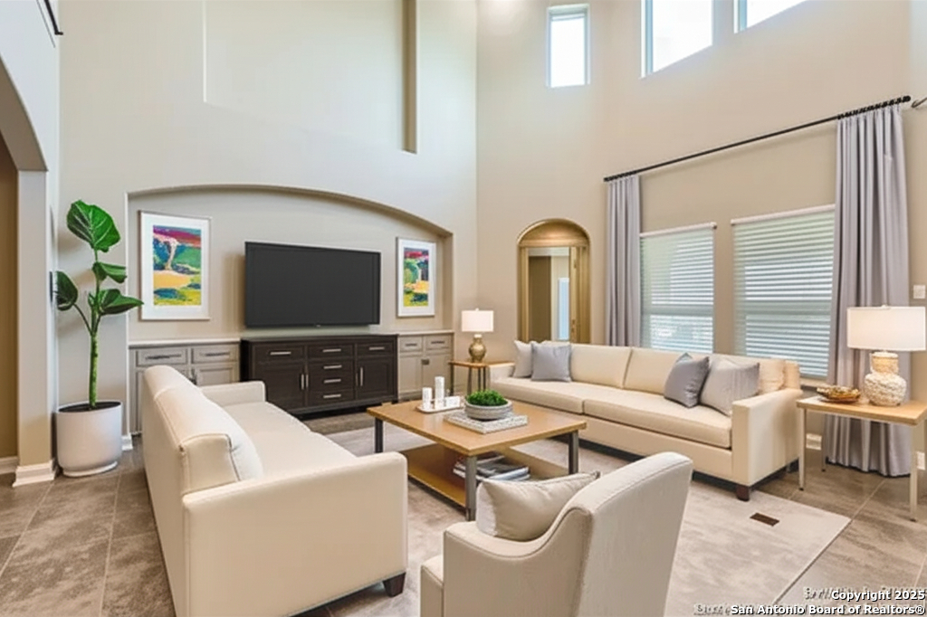14722 Rifleman Road San Antonio, TX 78254 - Photo 13 of 37 a living room with furniture a large window and a flat screen tv