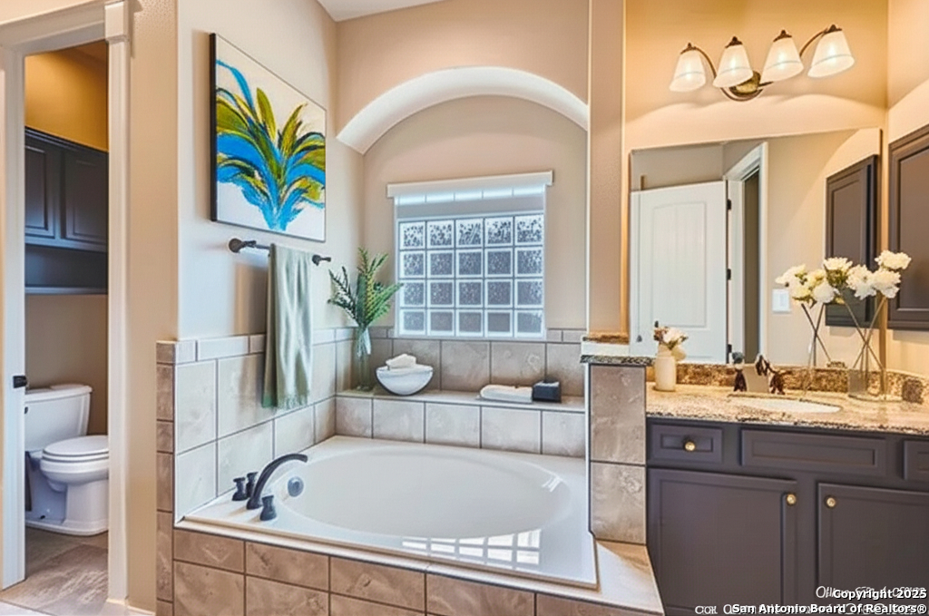 14722 Rifleman Road San Antonio, TX 78254 - Photo 17 of 37 a bathroom with a tub sink and mirror
