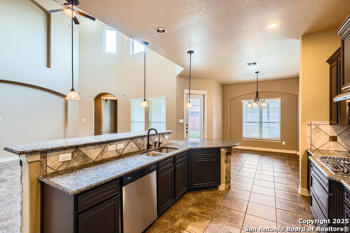 14722 Rifleman Road San Antonio, TX 78254 - Photo 10 of 37 a kitchen with a sink and a refrigerator