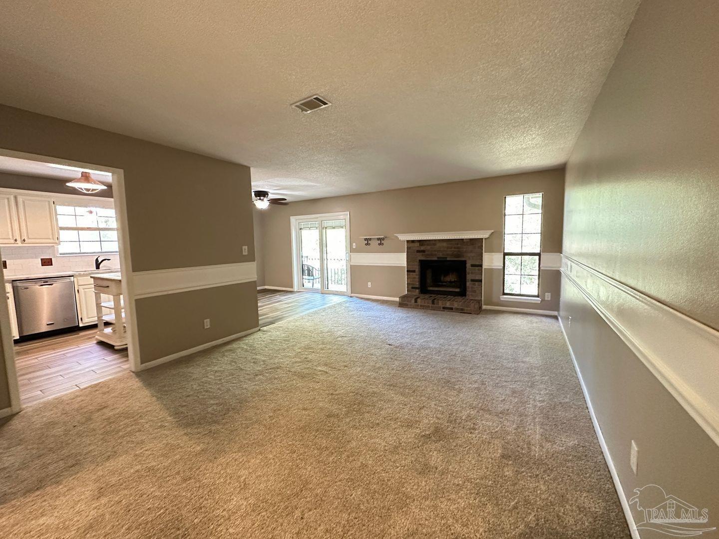 4831 East Olive Road, Unit 4D Pensacola, FL 32514 - Photo 2 of 17 an empty room with furniture and fireplace