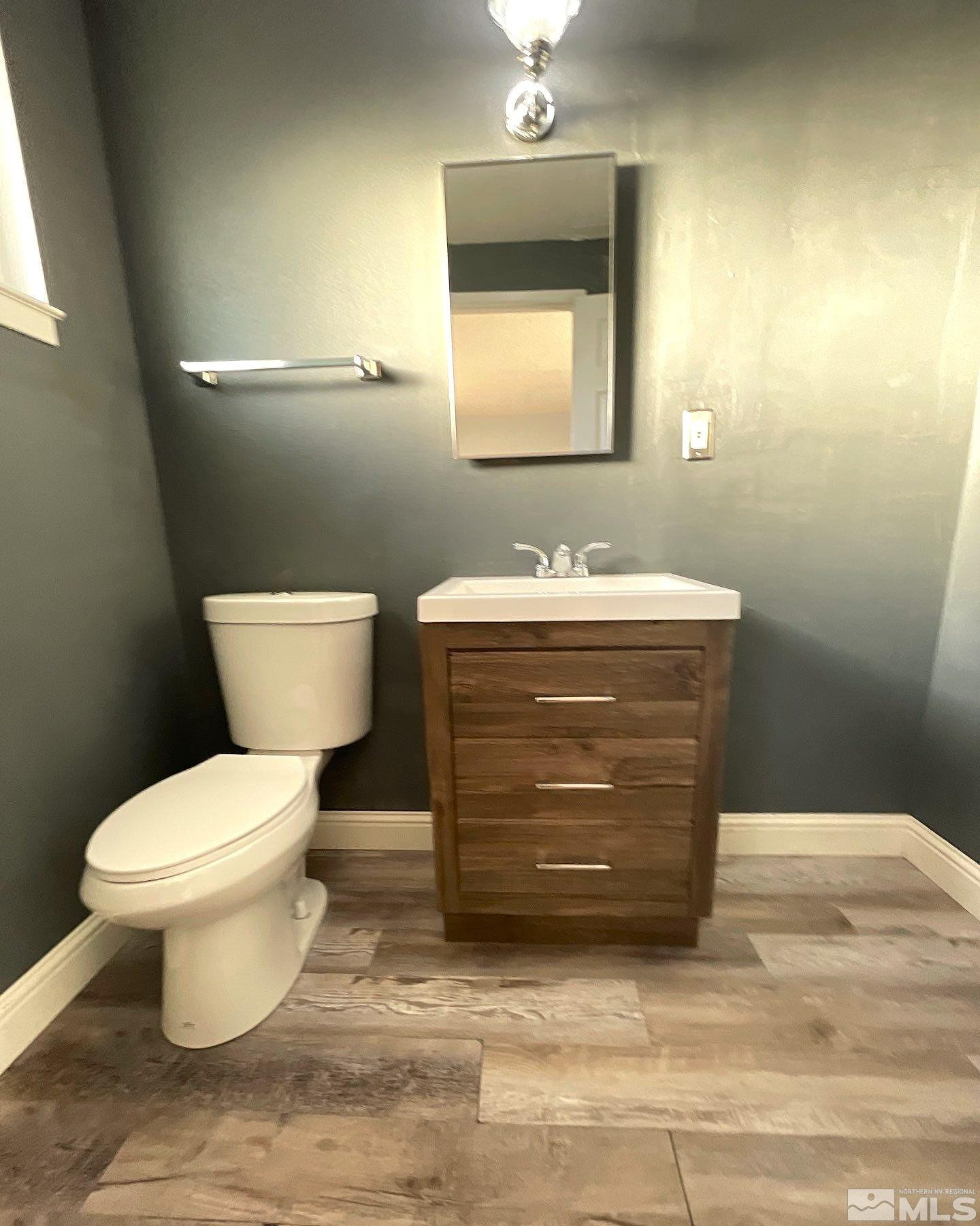 405 Kess Way Reno, NV 89506 - Photo 12 of 14 a bathroom with a toilet sink and mirror