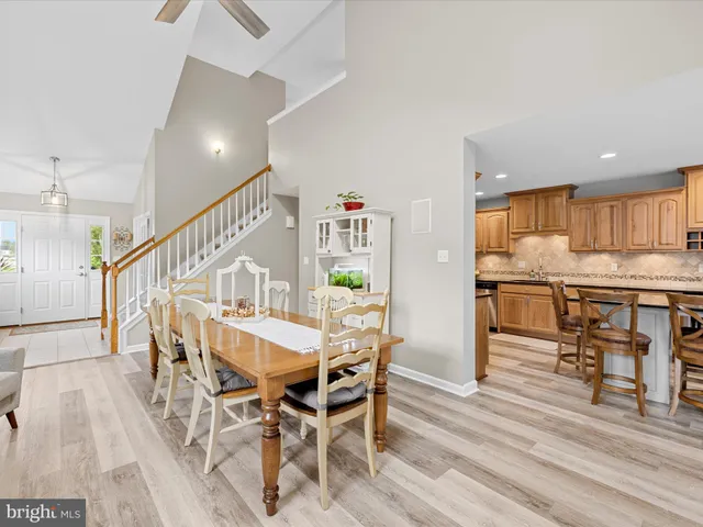 a dining room with furniture and wooden floor