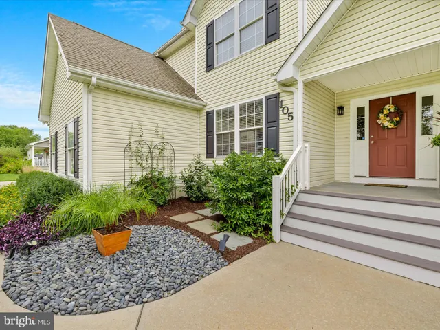 a front view of a house with plants
