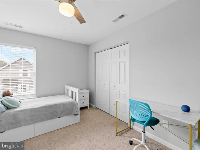 a bedroom with a bed and a chair