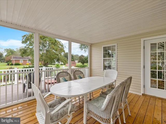 a view of a deck with furniture and garden