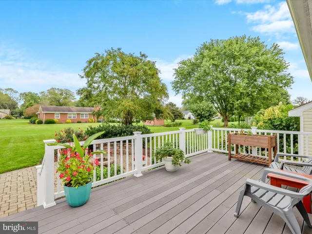 a view of a chair and table on the wooden deck
