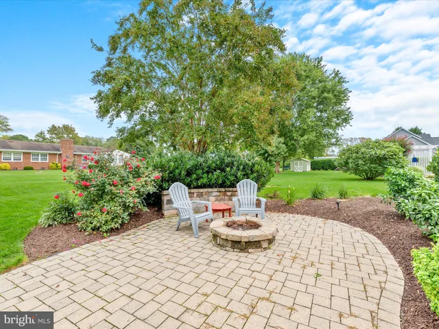 a view of a house with a yard table and chairs